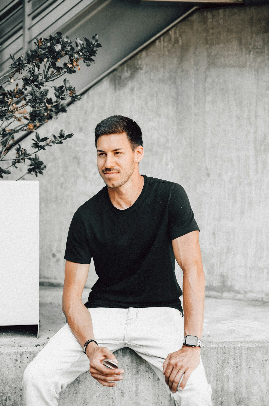 Portrait of a smiling man with short dark hair in a business casual outfit